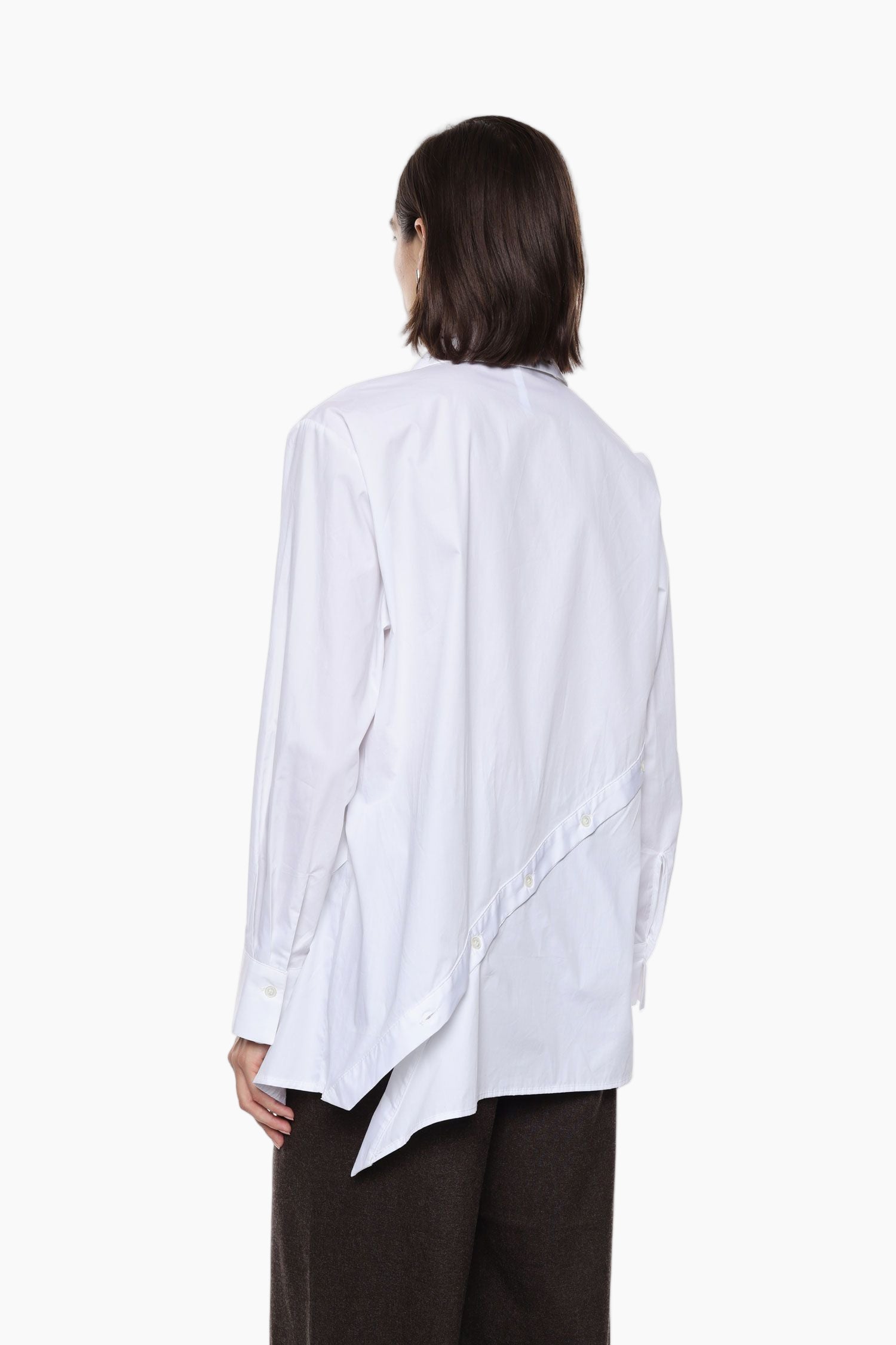 Person wearing a white shirt with an asymmetrical hem