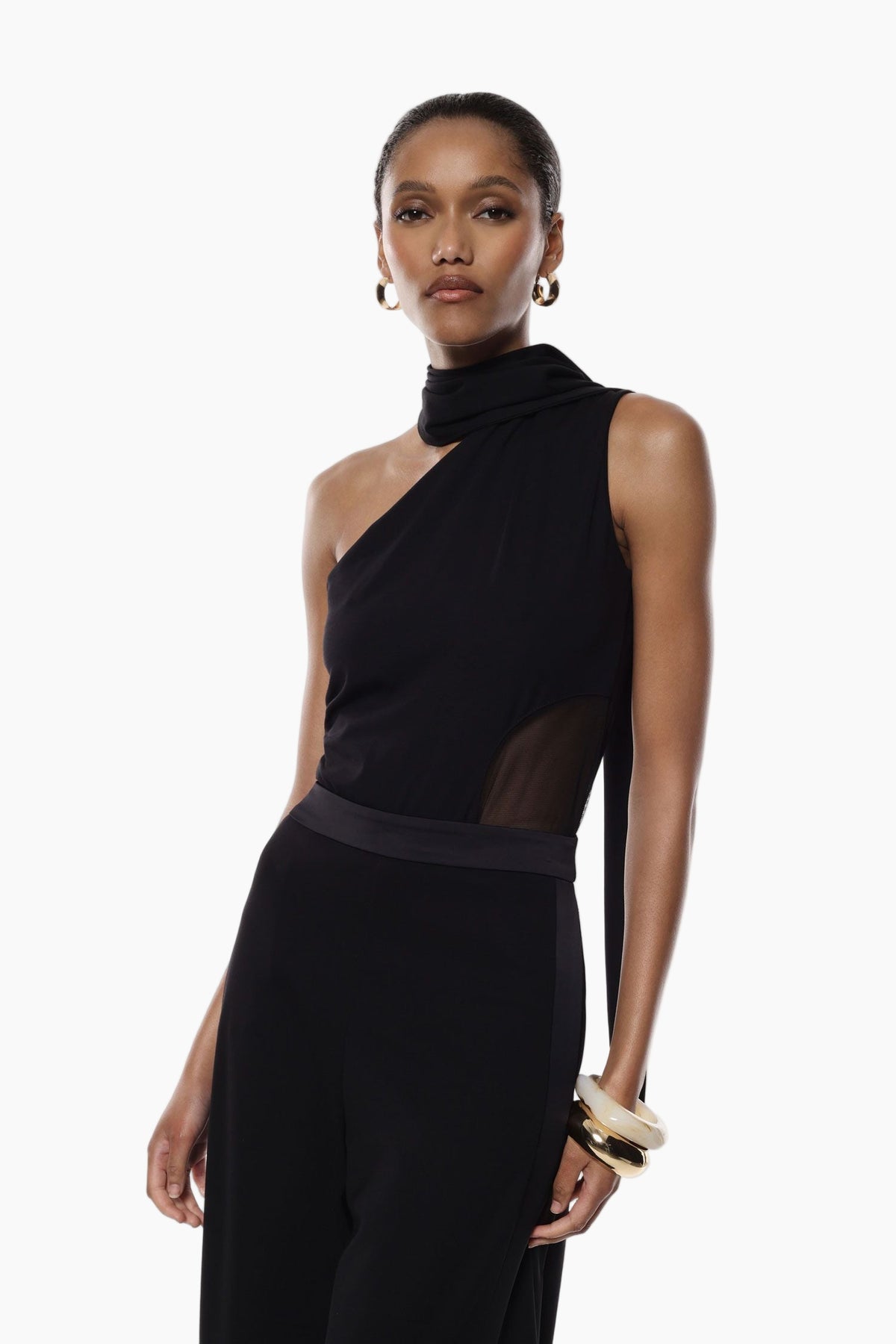 Woman wearing a black one-shoulder bodysuit