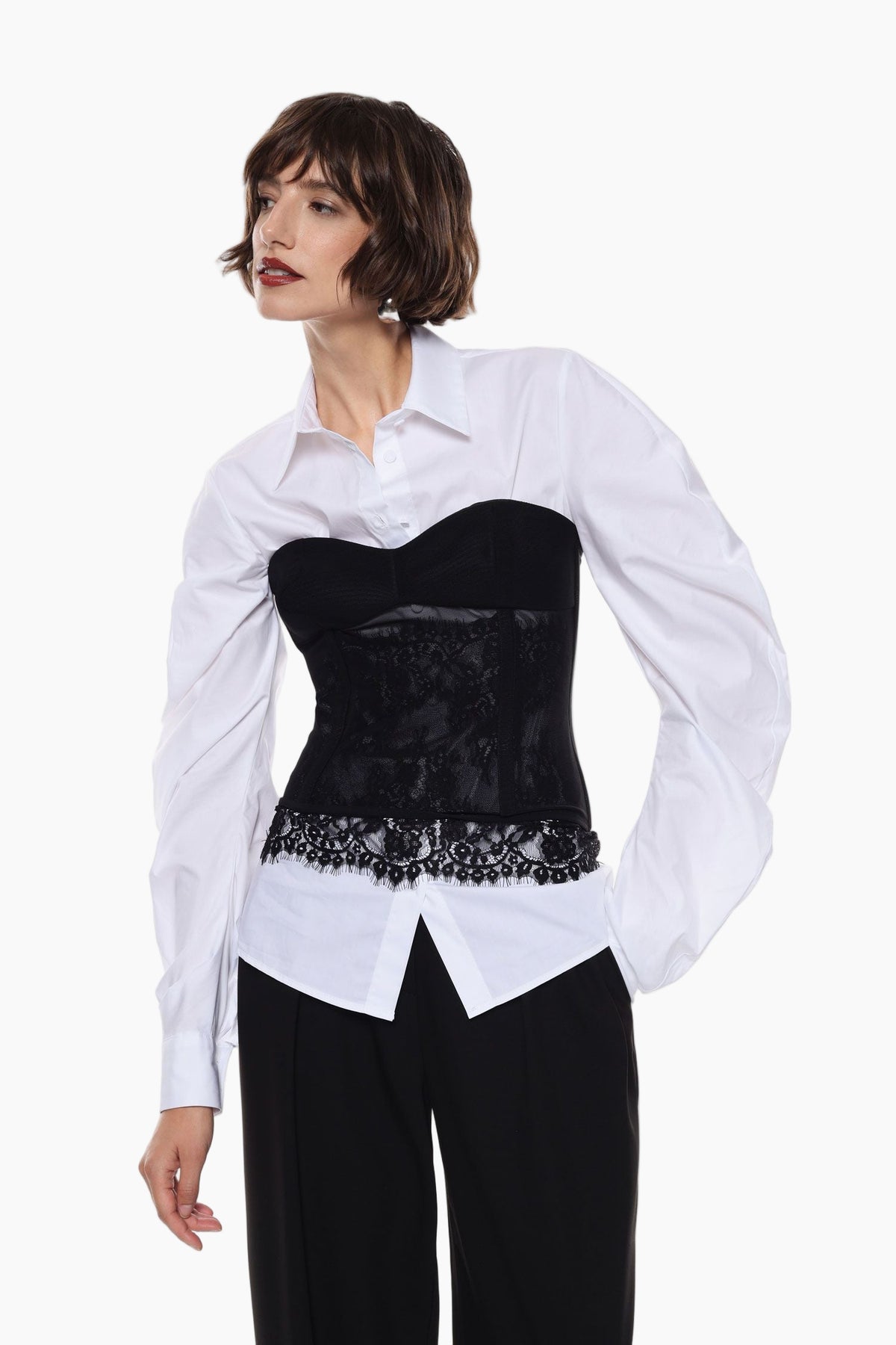 Woman wearing a white shirt over a black lace top