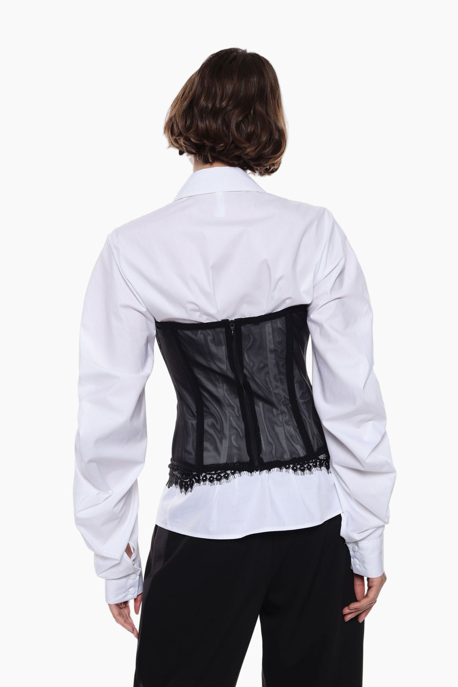 Person wearing a white shirt with a black mesh panel