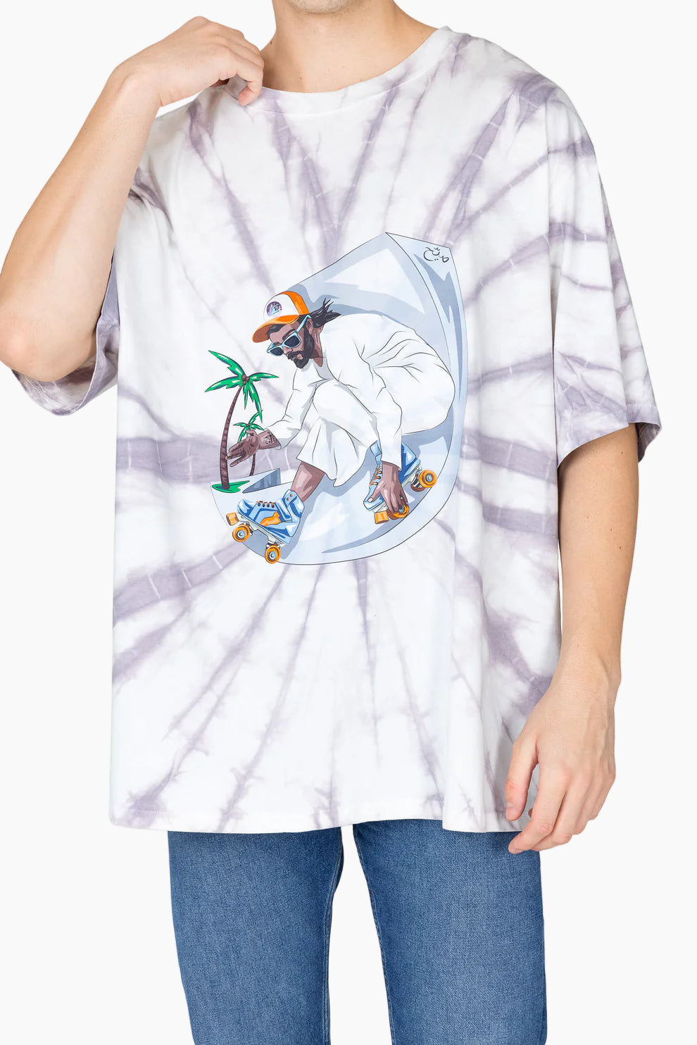Person wearing a tie-dye t-shirt with a graphic design of a person on a skateboard and palm trees.