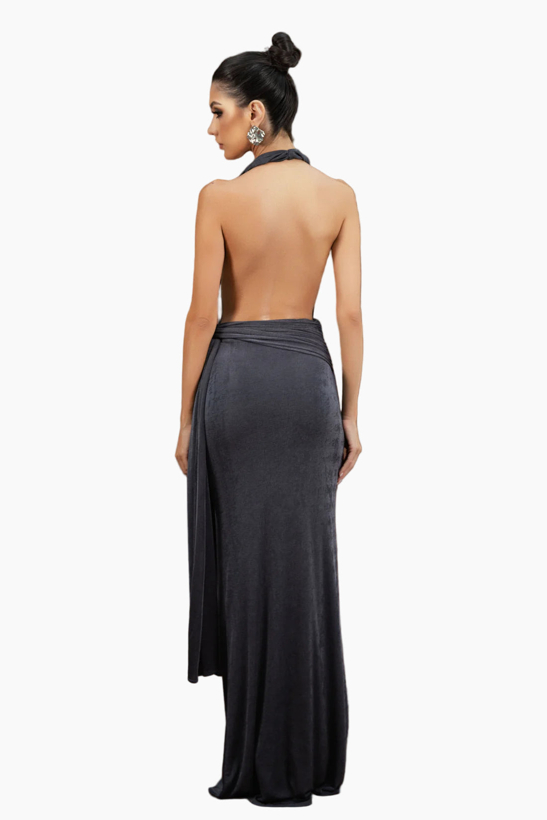 Woman wearing a dark gray strapless gown against a brown background