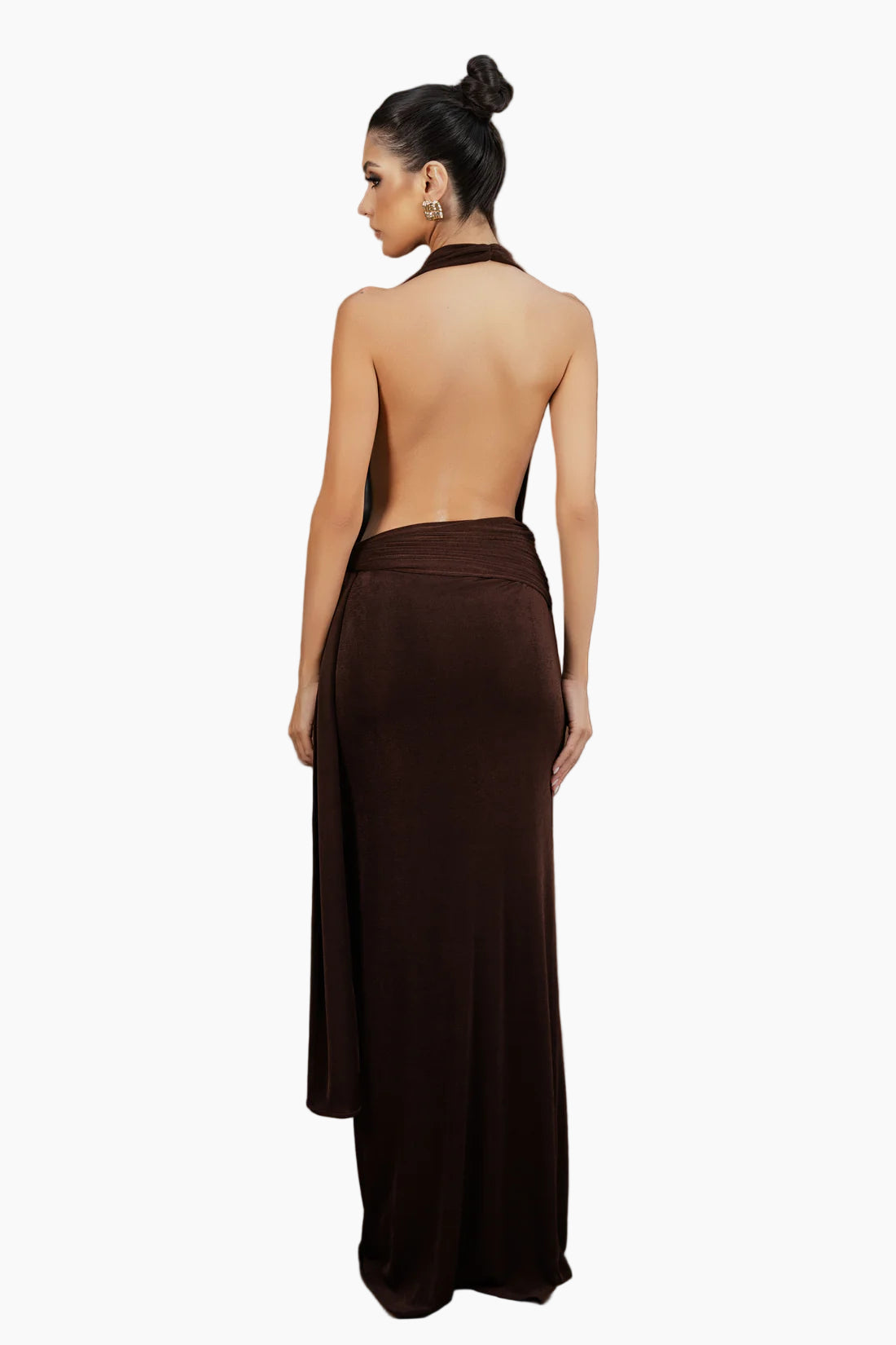 Woman wearing a brown dress with an open back against a brown background
