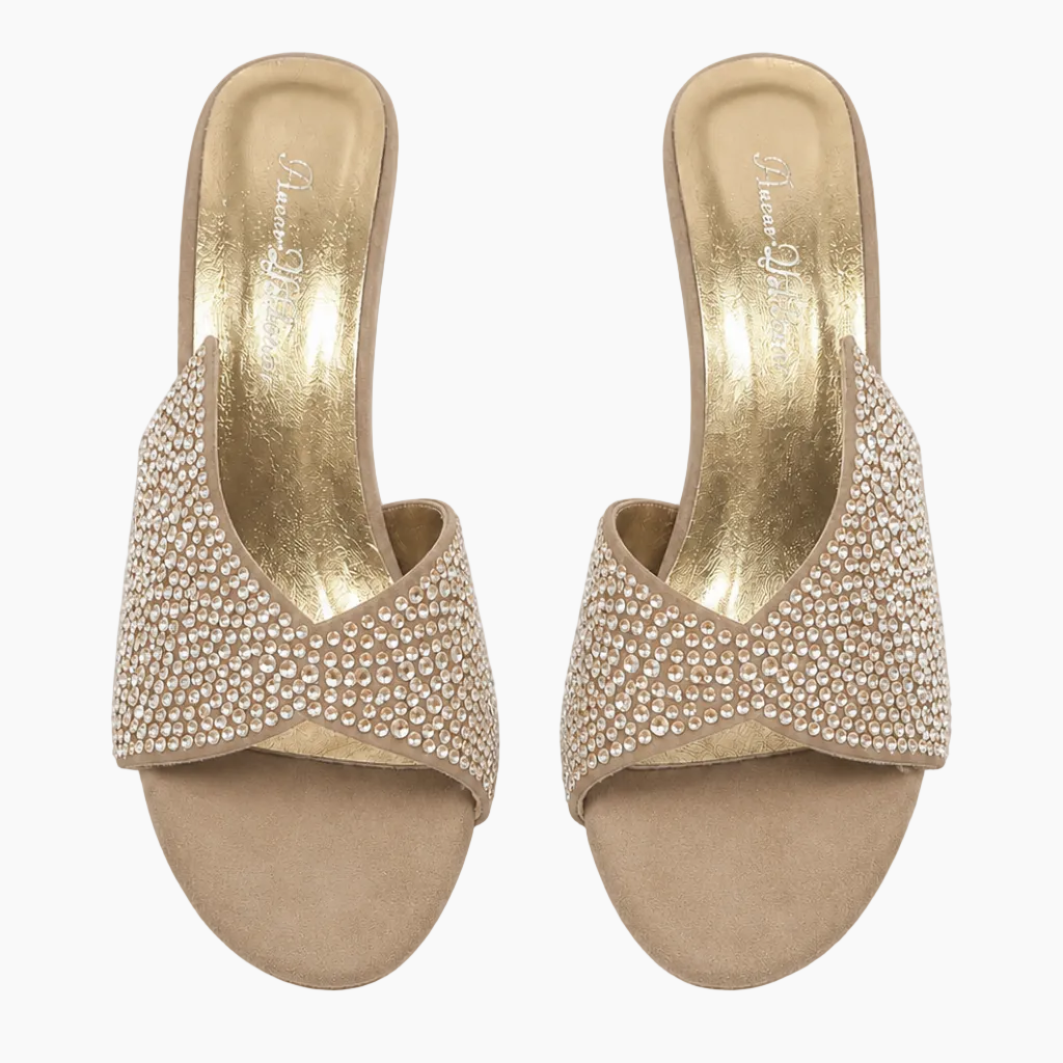 A pair of women's slide sandals with metallic gold insoles and straps heavily embellished with small clear rhinestones, shown from a top-down view on a white background.