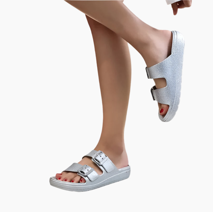 Silver sandals worn by a person