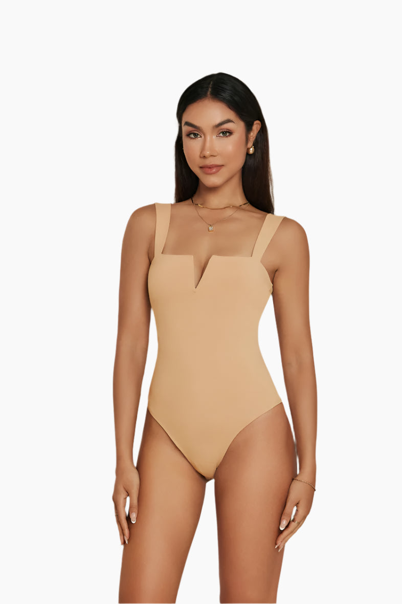 Woman wearing a beige swimsuit