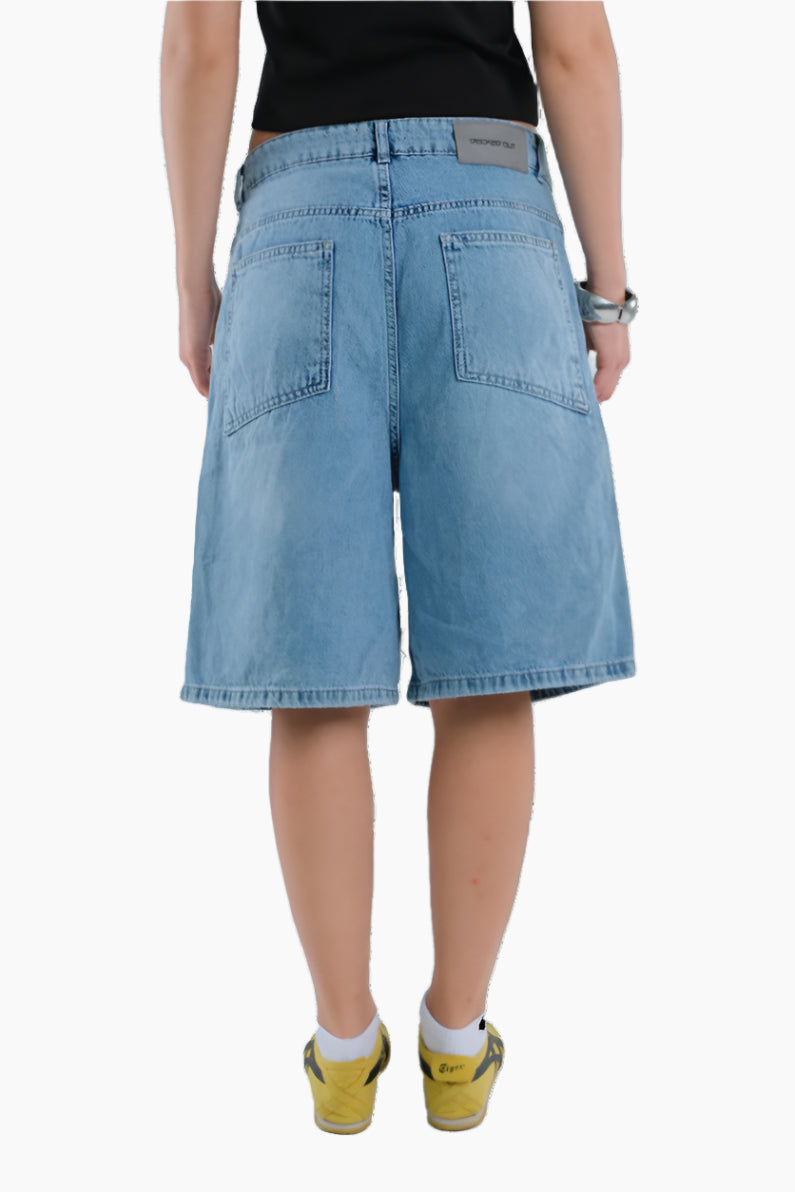 Person wearing light blue denim shorts