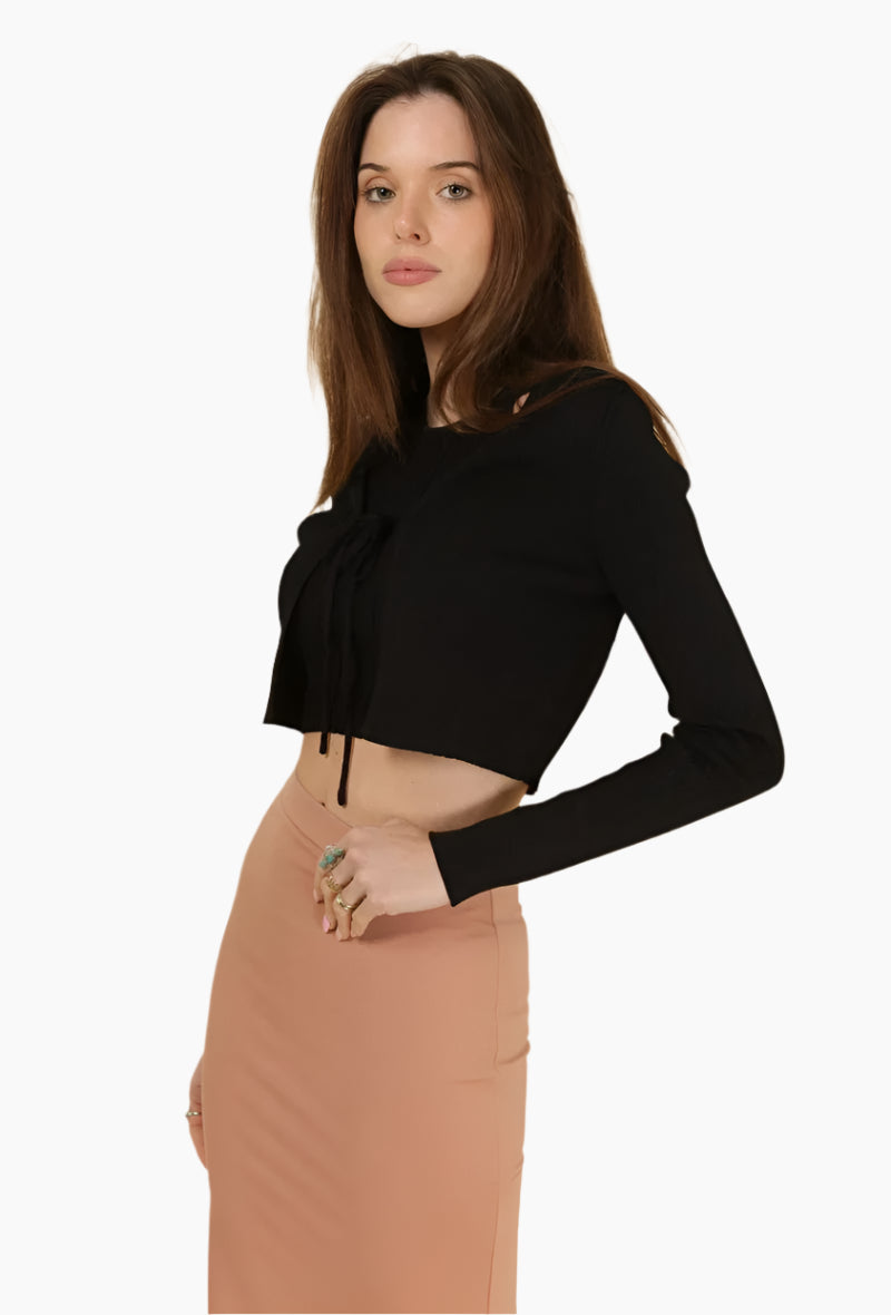 Woman wearing a black long-sleeve top and brown skirt