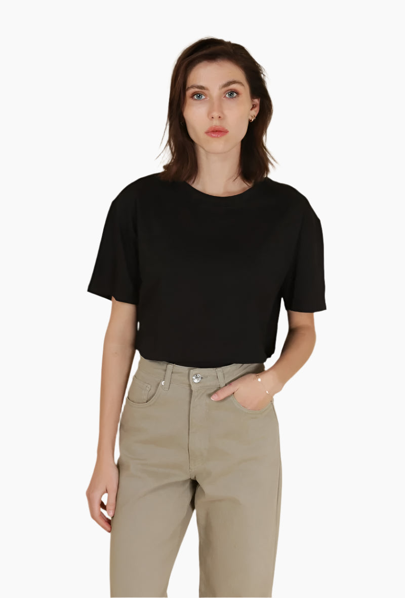 Woman wearing a black t-shirt and beige pants