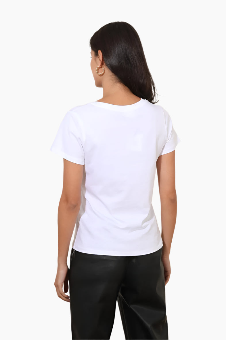 Person wearing a white t-shirt and black pants