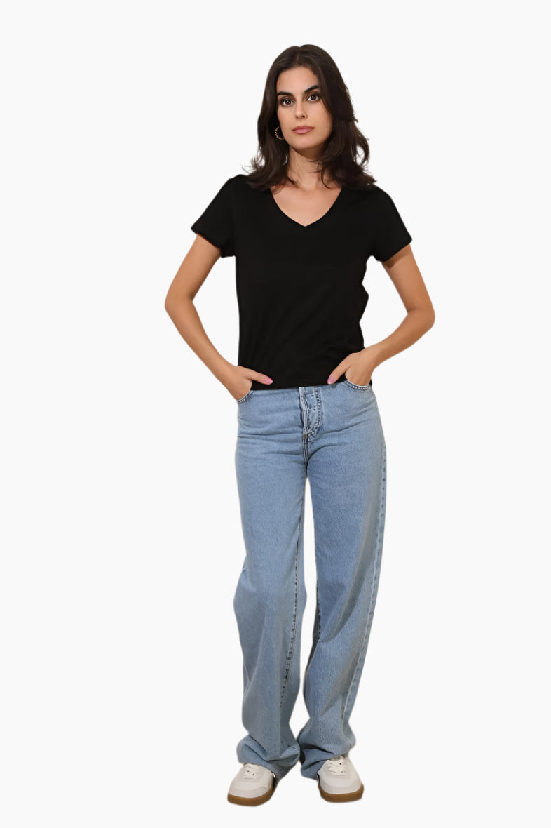Woman wearing a black t-shirt and light blue jeans