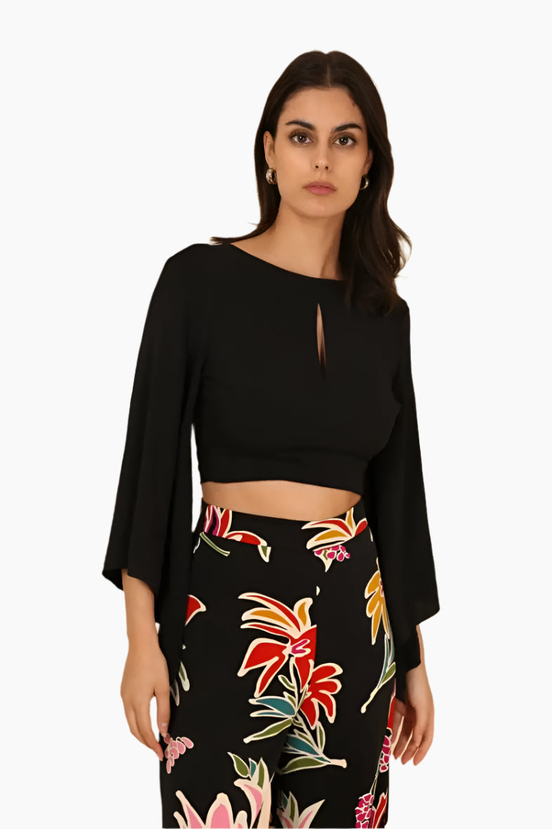Woman wearing a black top and floral skirt
