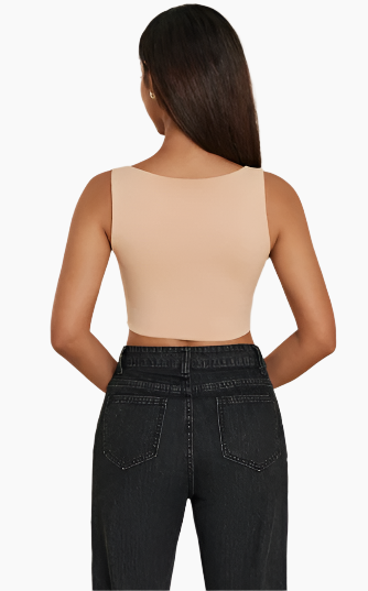 Person wearing a beige tank top and black jeans