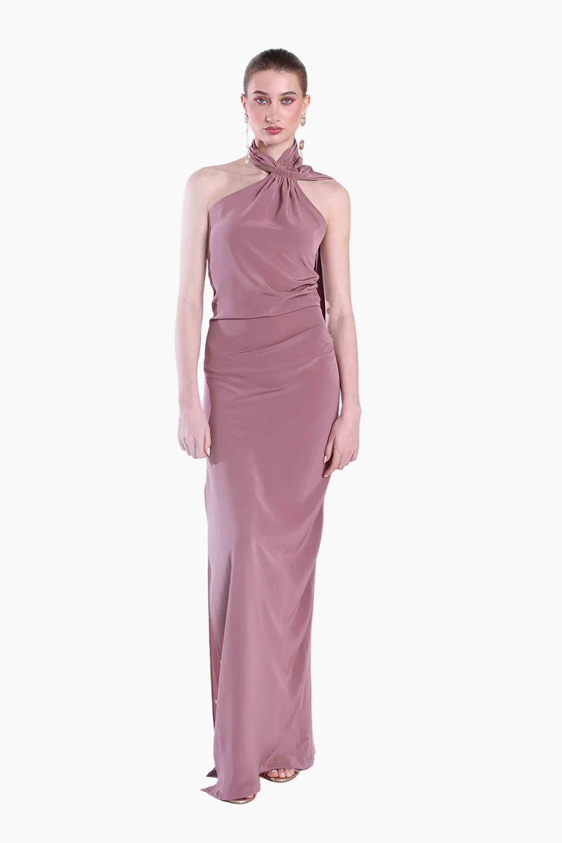 Woman wearing a mauve halter neck gown on a white background