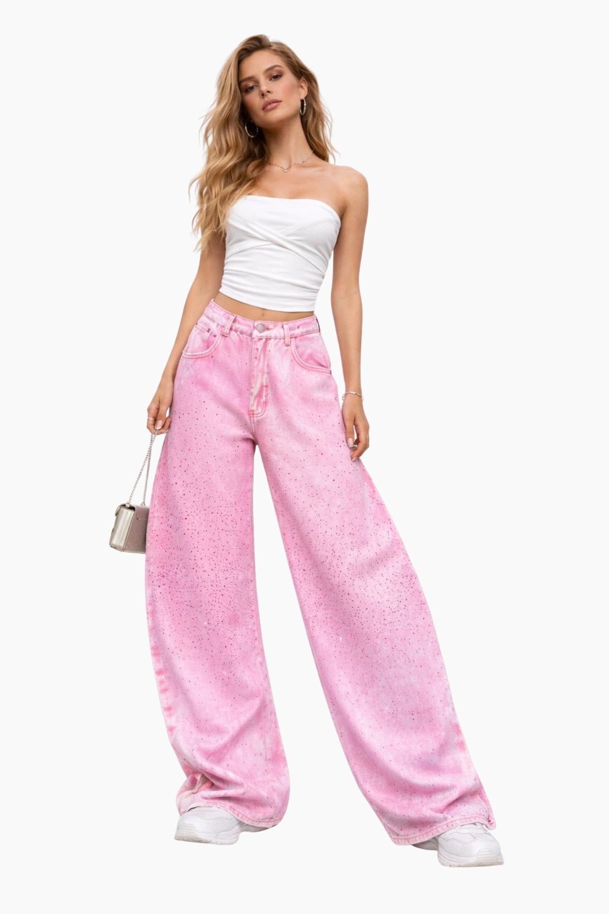 Woman wearing a white strapless top and pink wide-leg jeans on a white background
