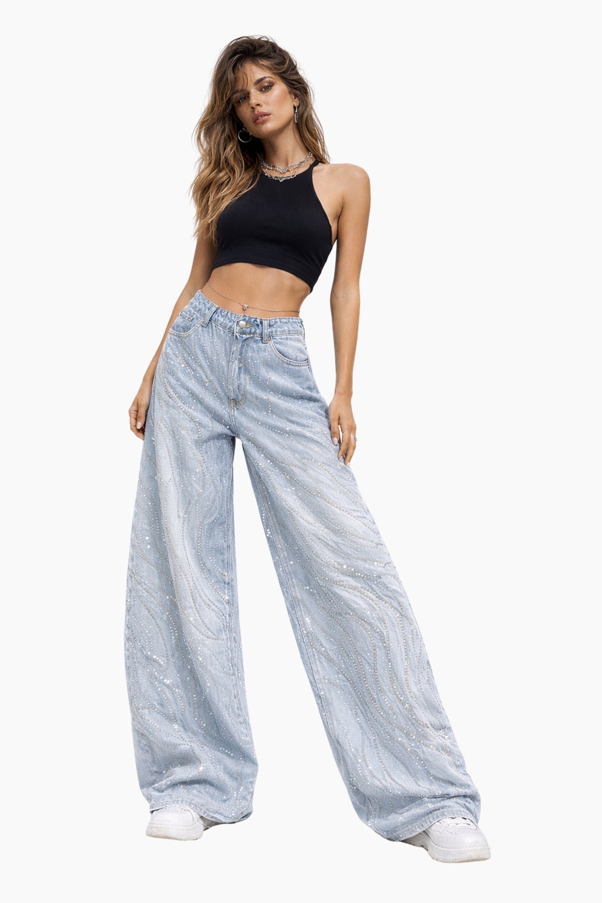 Woman wearing light blue jeans and a black top on a white background