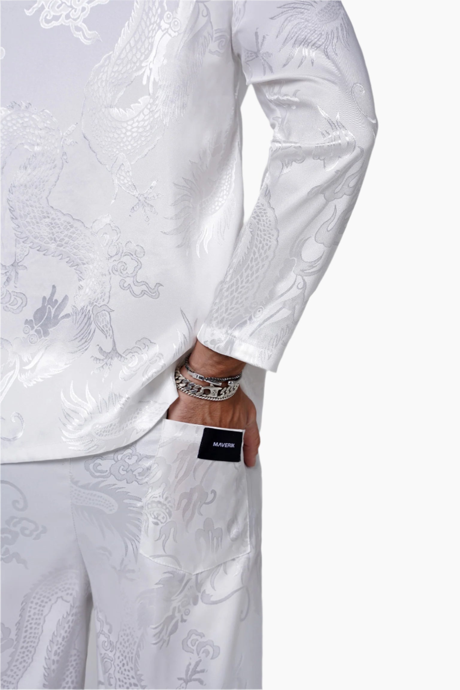 White embroidered outfit with a visible brand label