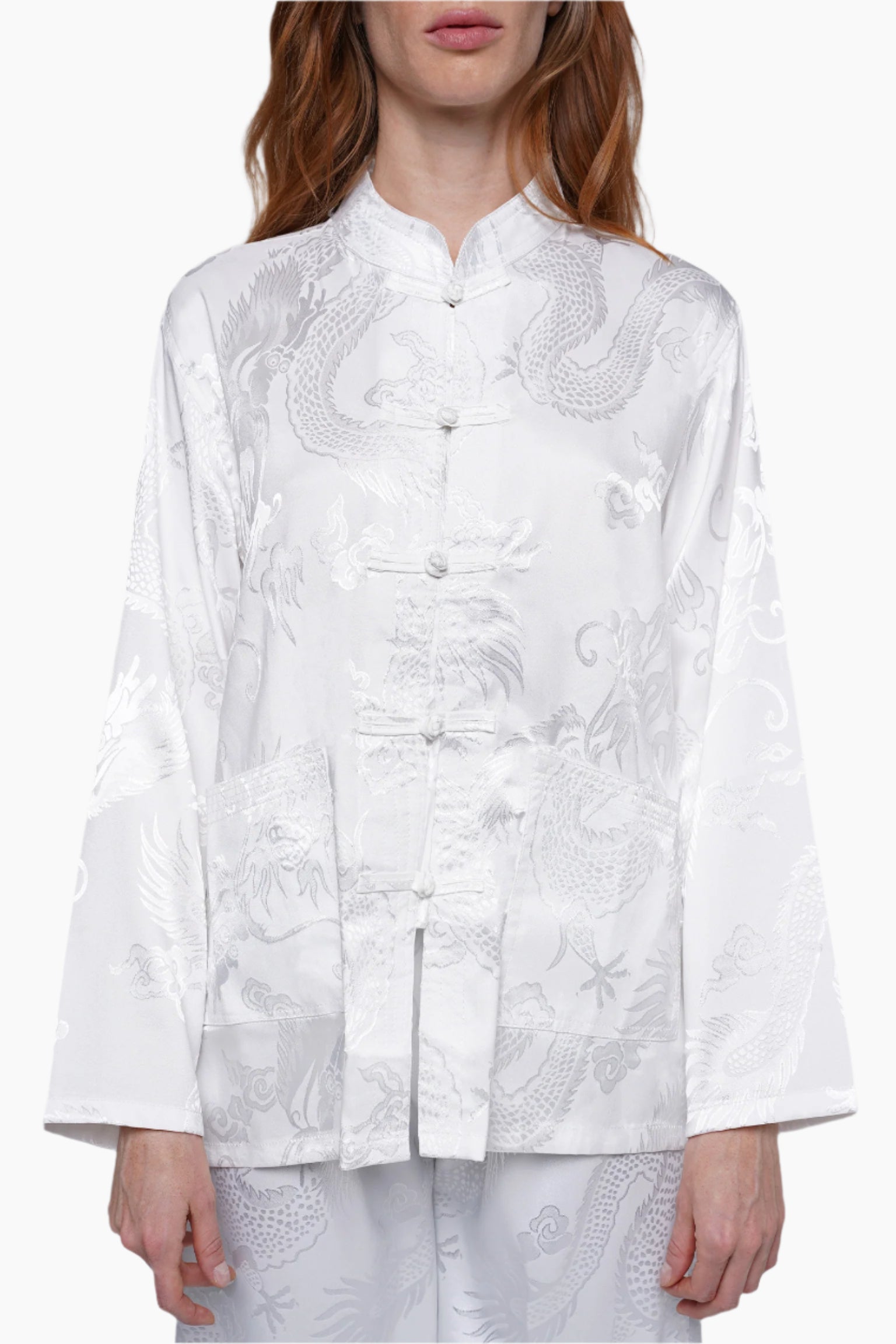 White embroidered traditional jacket worn by a person