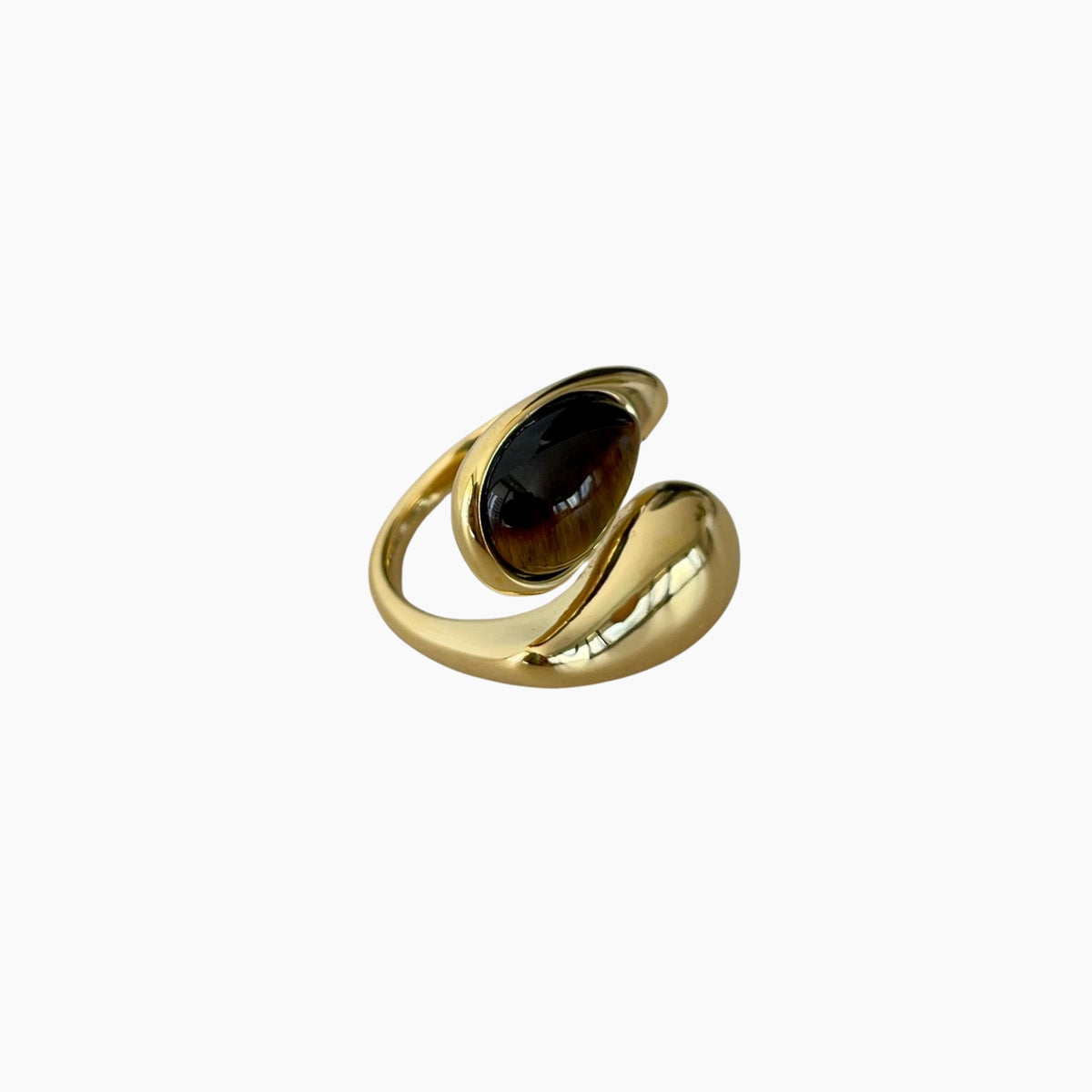 Gold ring with a dark gemstone on a white background