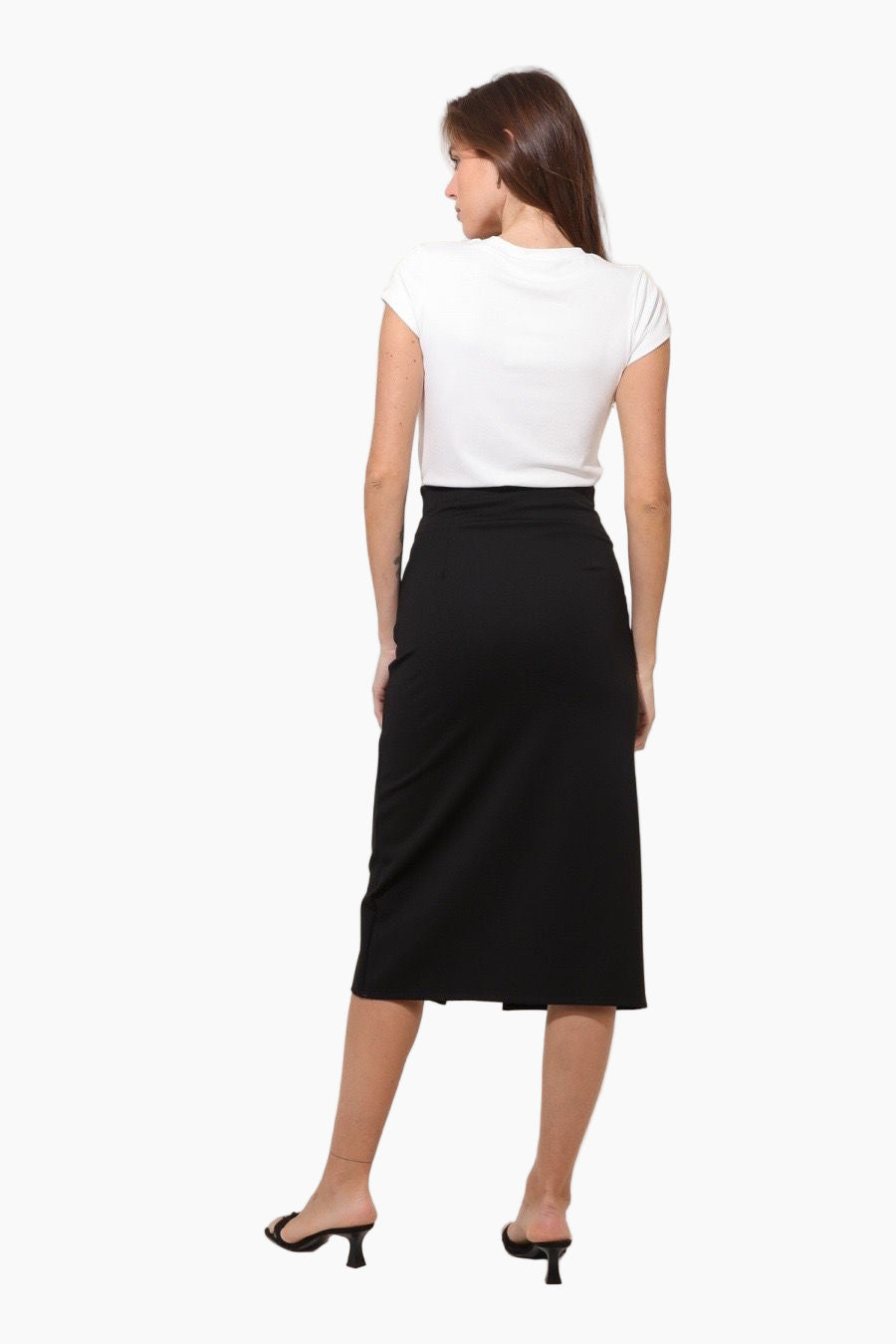 Woman wearing a white top and black skirt