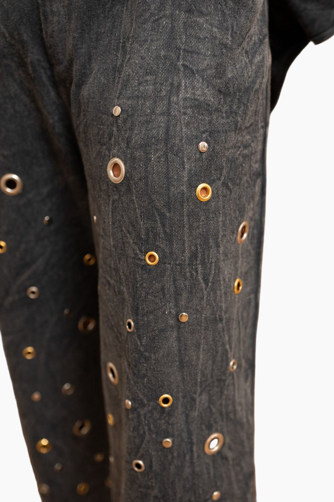 Close-up of a dark fabric garment with decorative buttons