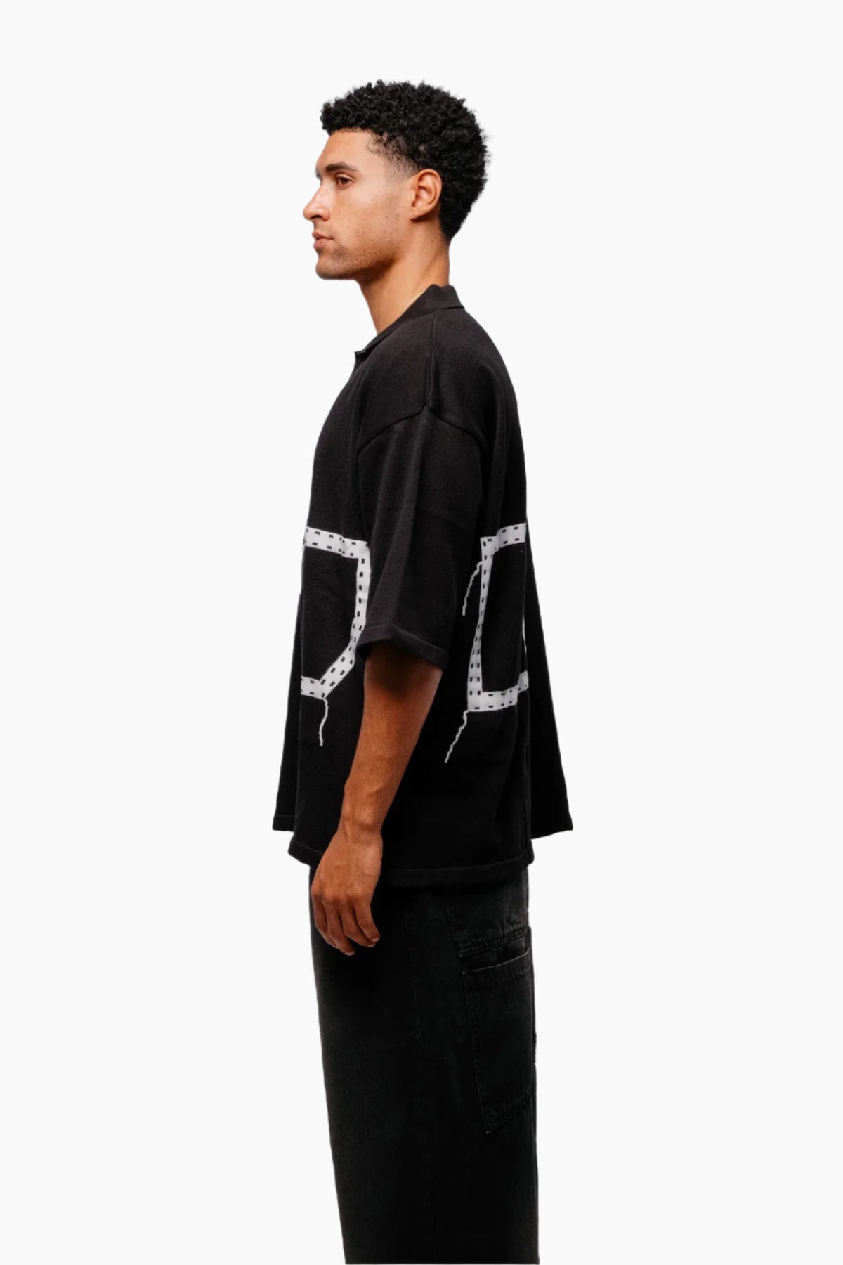 Man wearing a black t-shirt with a unique design pocket