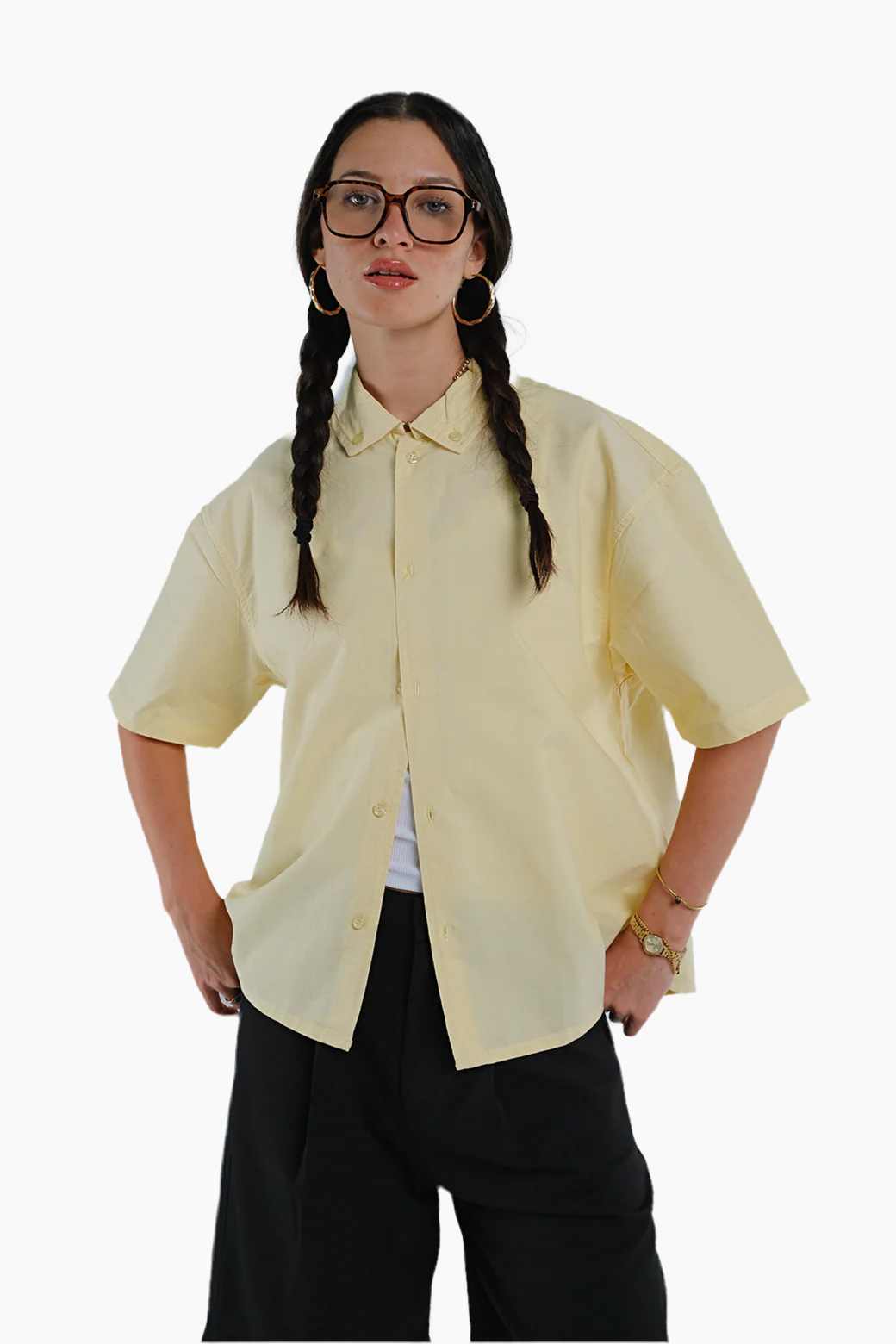 Woman wearing a light yellow shirt and black pants