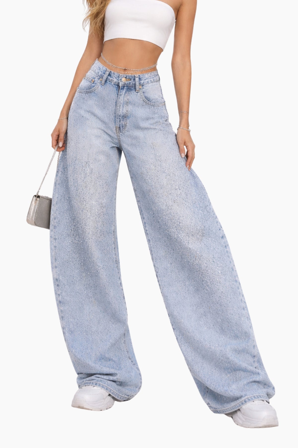Person wearing light blue wide-leg jeans and a white top on a white background