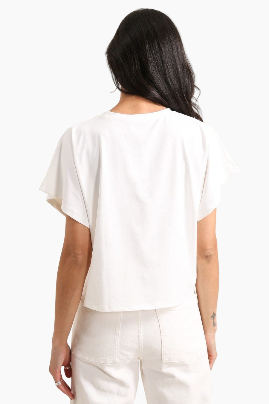 Person wearing a white blouse and pants