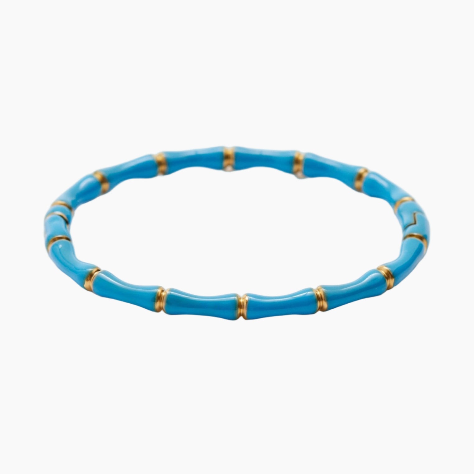Blue bracelet with gold accents on a white background