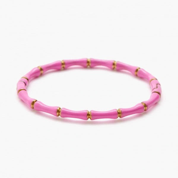 Pink beaded bracelet with gold accents on a white background