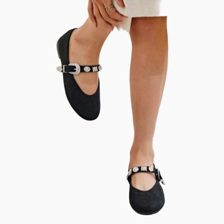 Black ballet flats with silver buckles worn