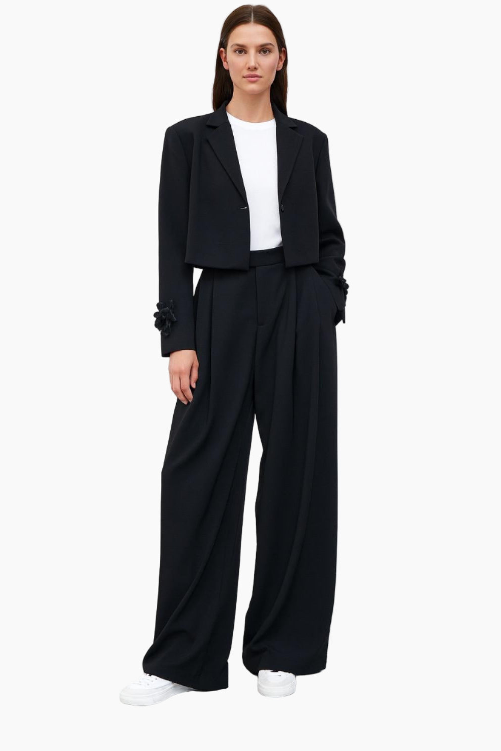 Woman wearing a black suit with a white shirt