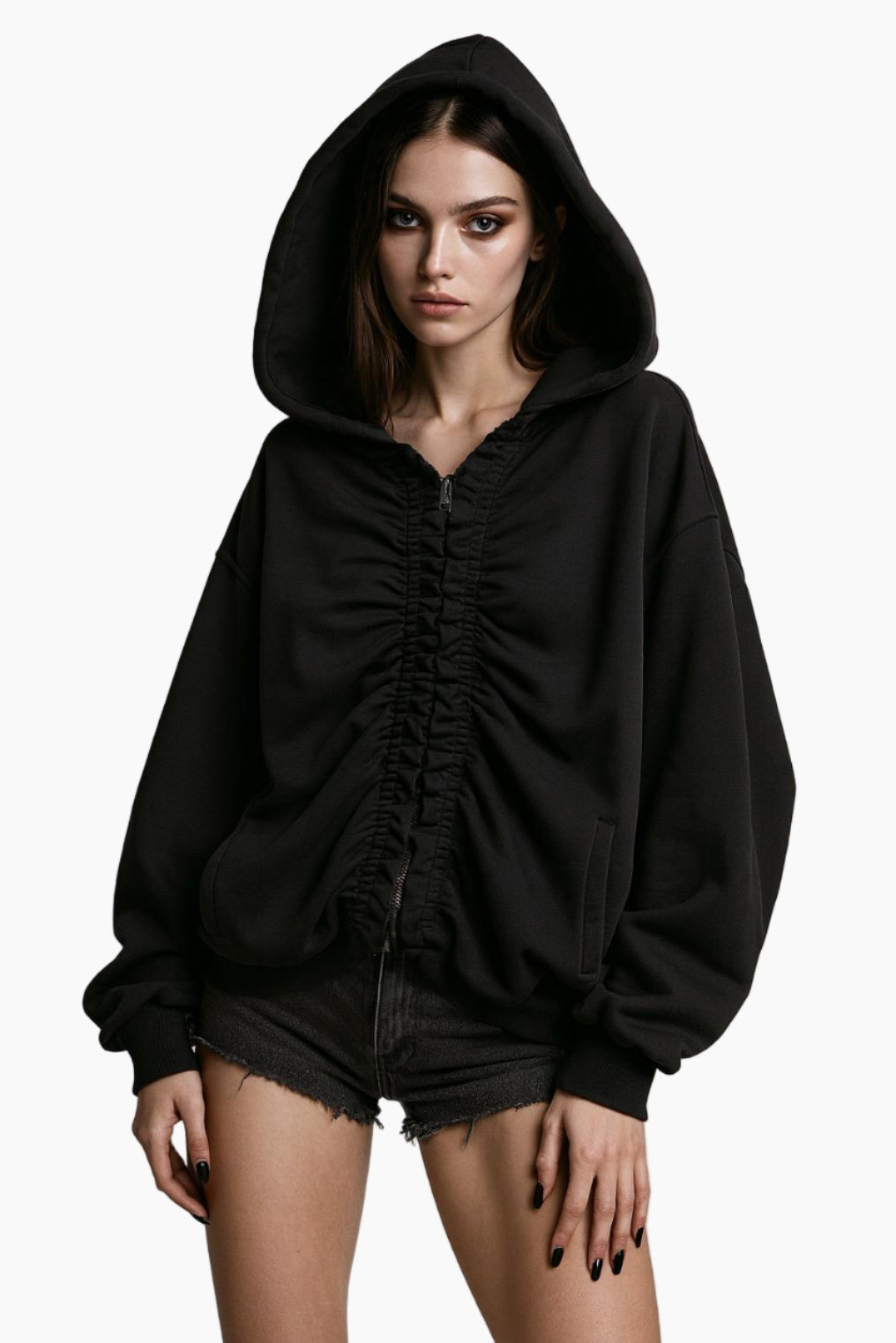 Person wearing a black hoodie and denim shorts