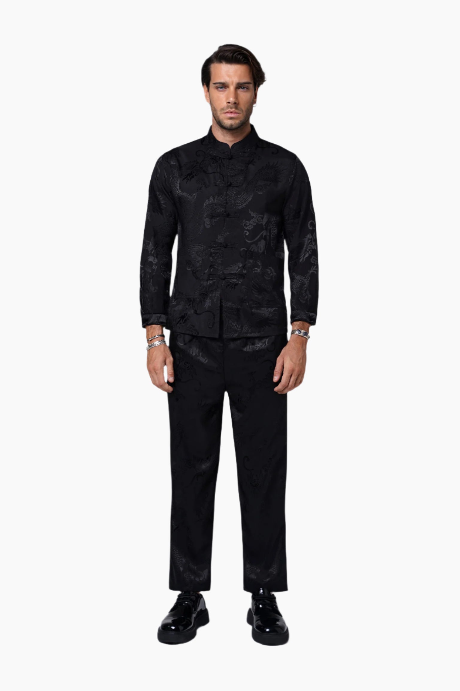 Man wearing a black patterned shirt and black pants