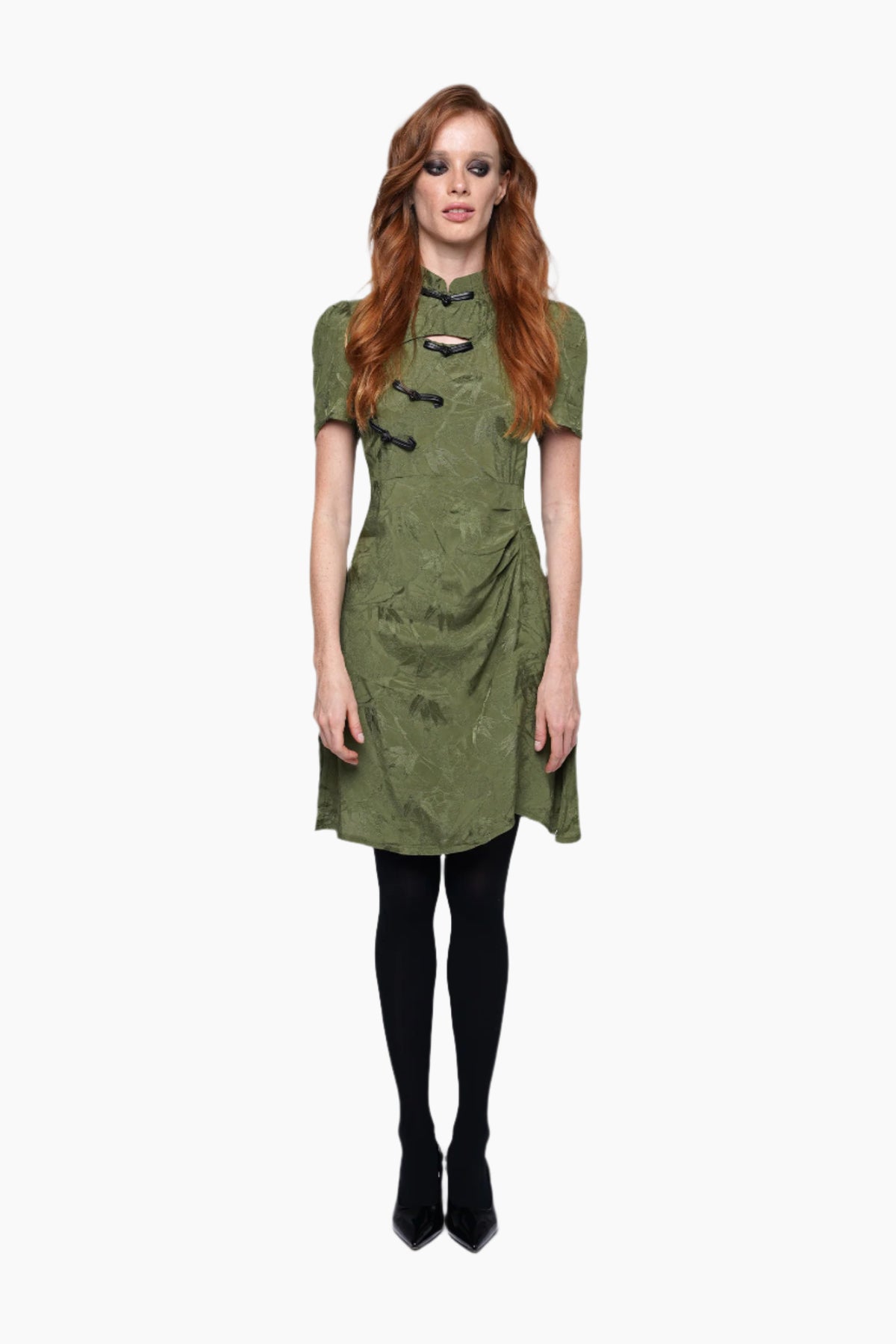 Woman wearing a green dress with black tights
