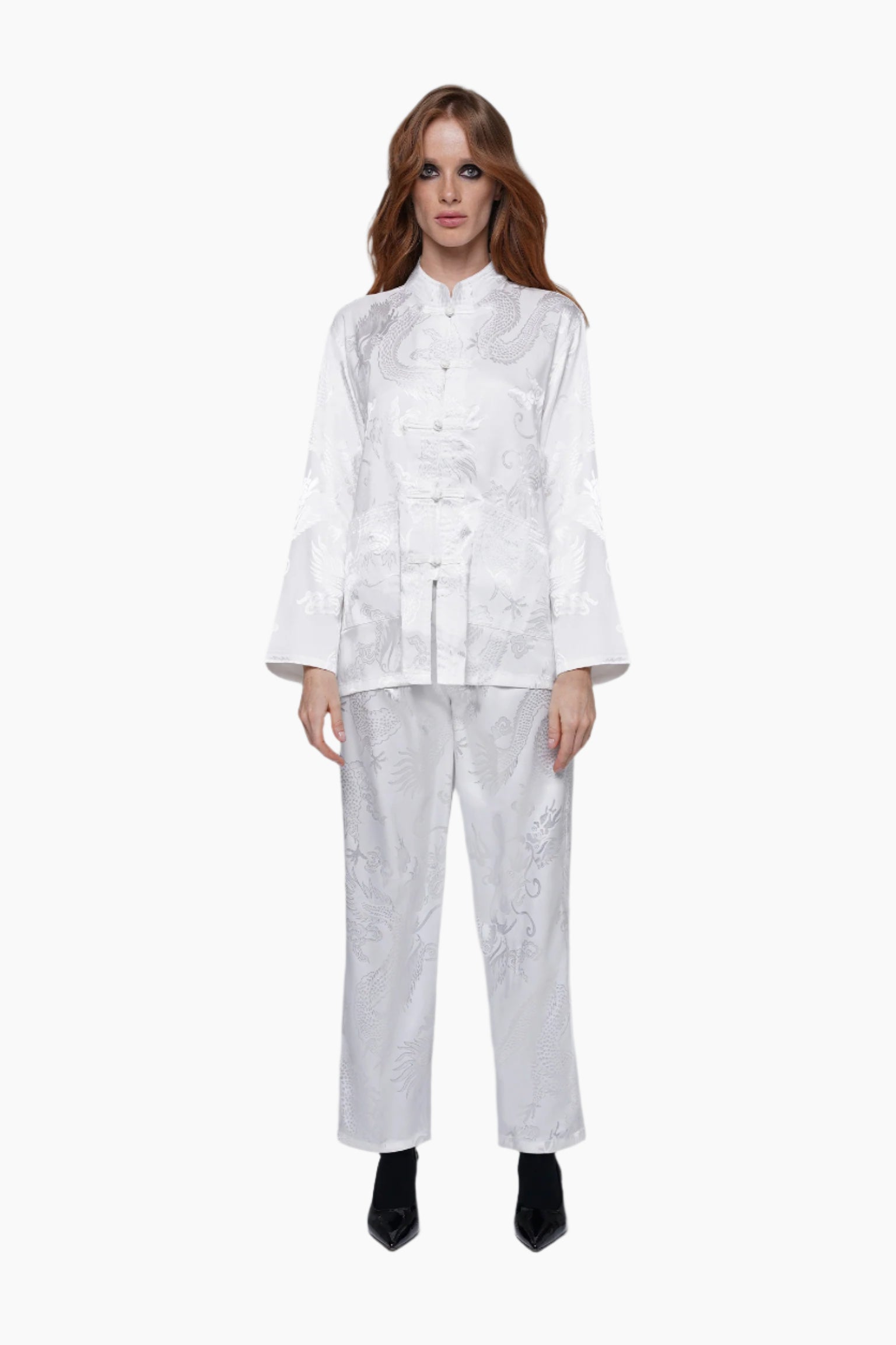 Woman wearing a white outfit with a pattern