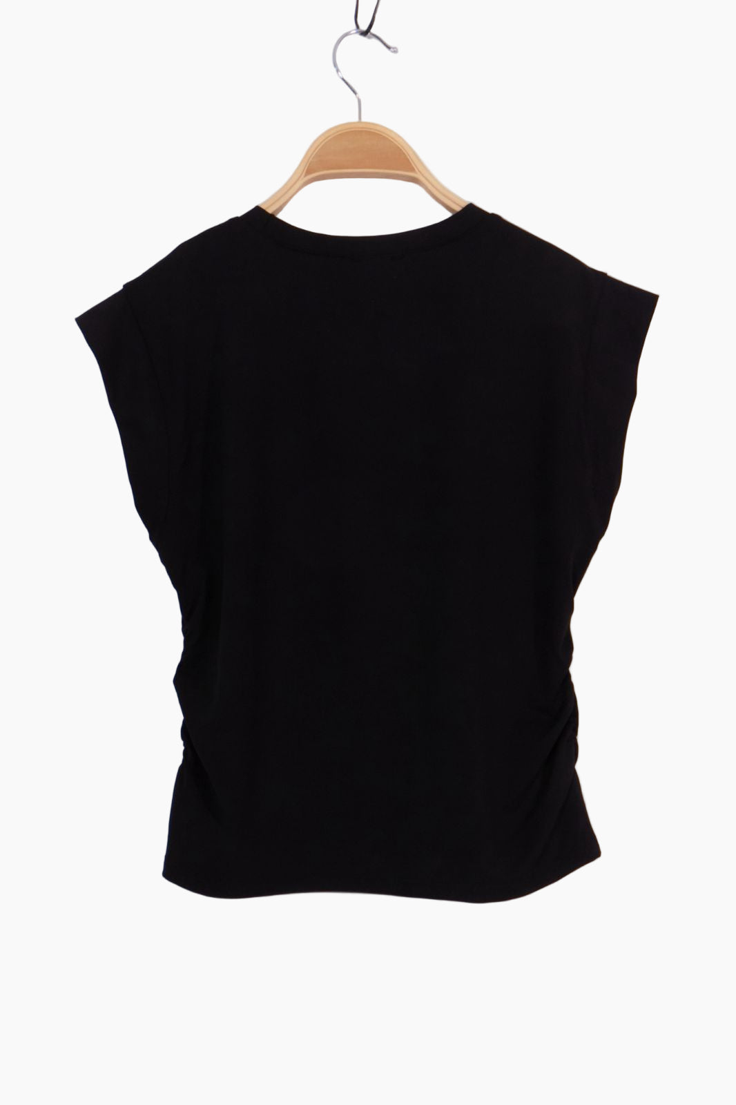 Black sleeveless top on a wooden hanger