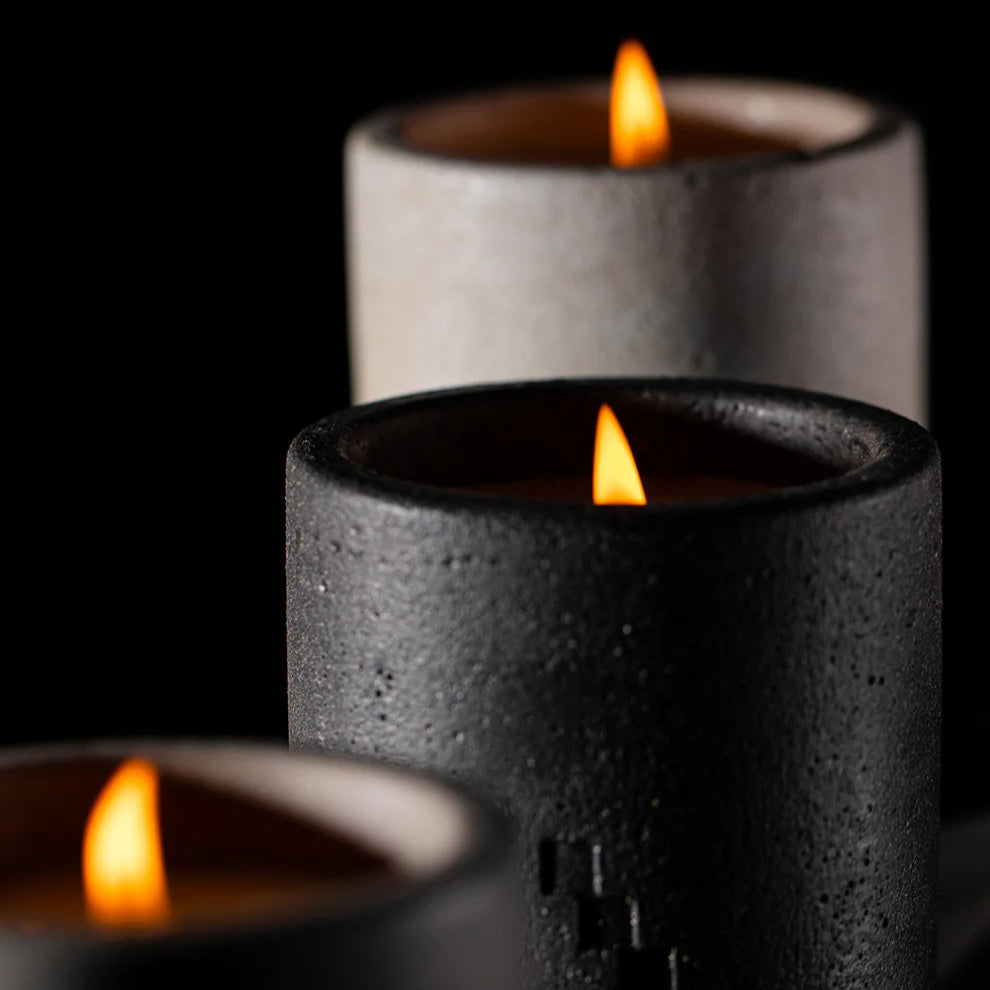 Three candles in black and gray holders