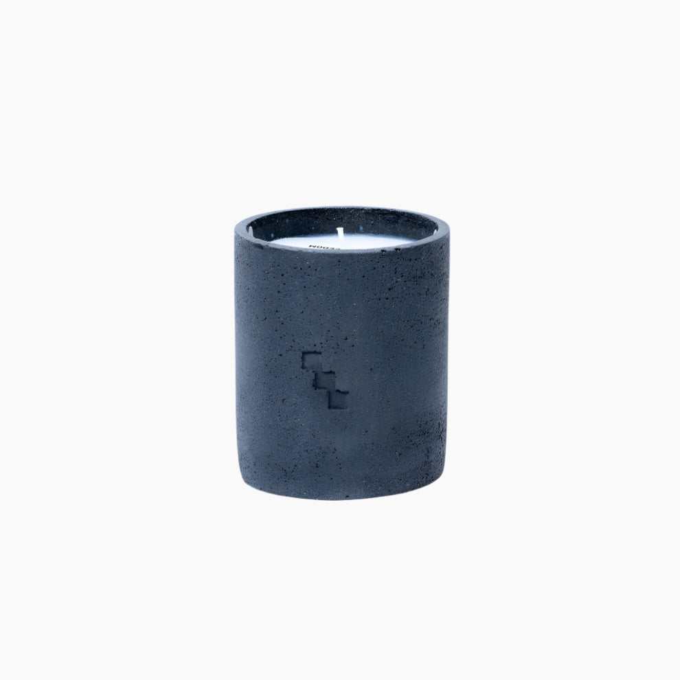 Dark gray concrete candle holder with a small candle