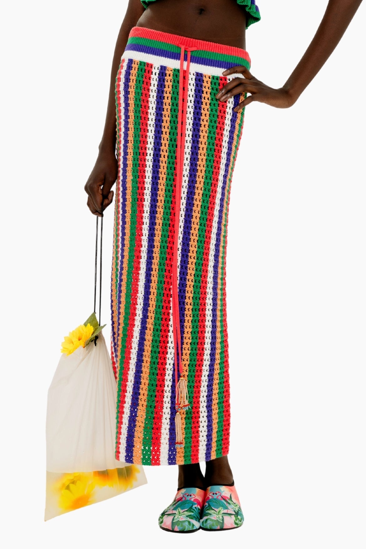 Person wearing a Colorful striped crochet skirt with a fitted silhouette and tassel detail.