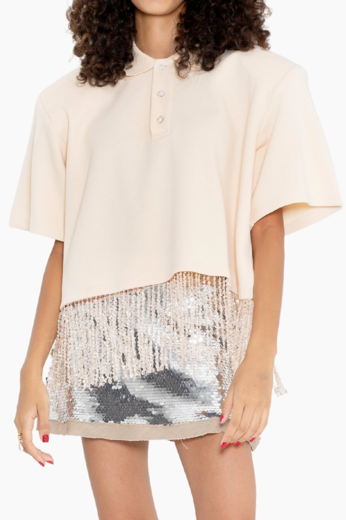 Woman wearing a beige blouse and sequin skirt