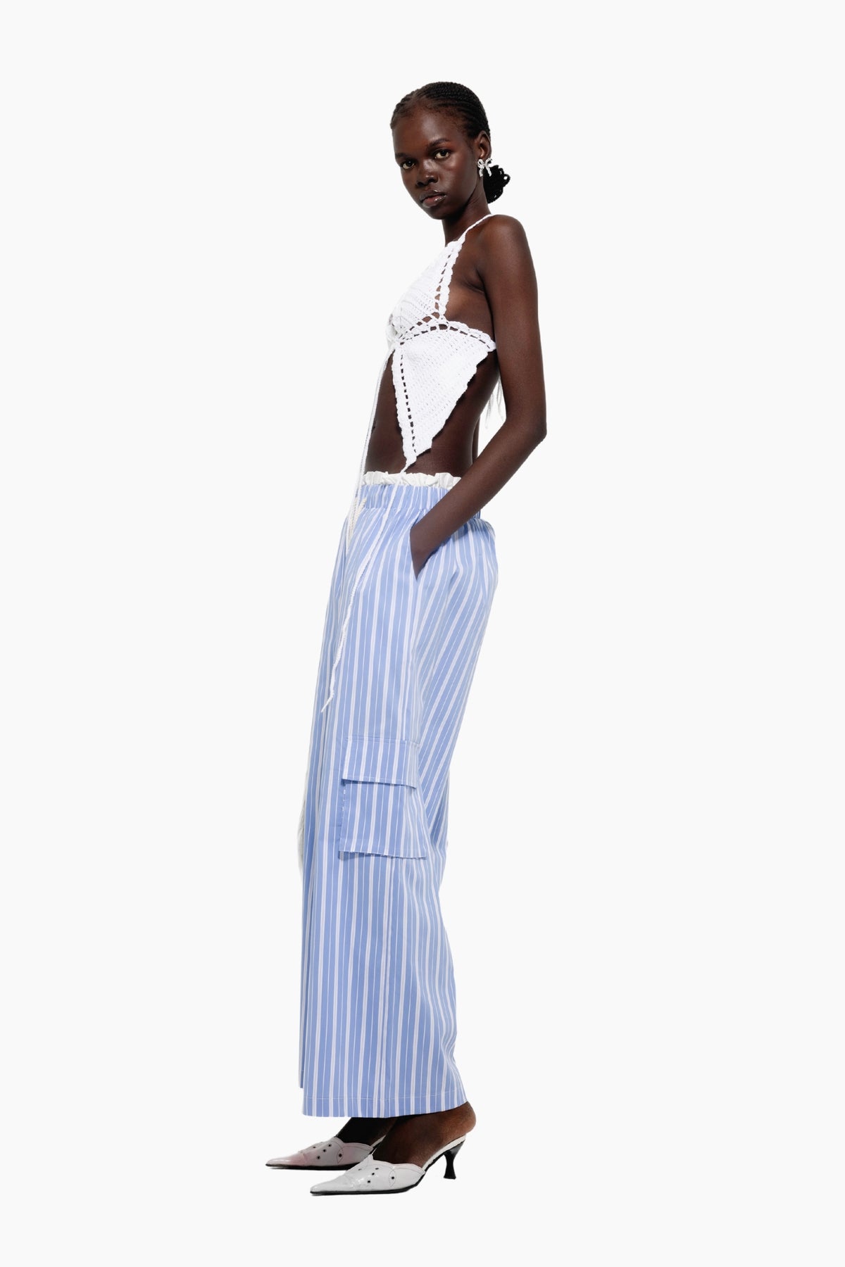 Woman wearing a white top and blue striped pants