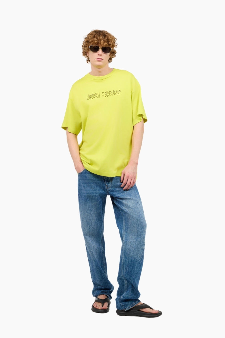 Person wearing a bright yellow t-shirt and blue jeans