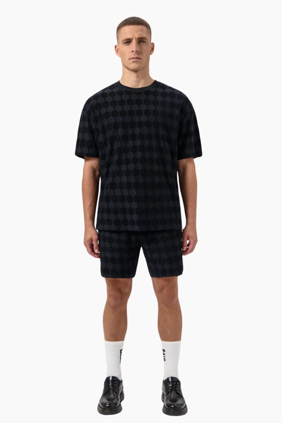 Man wearing a black checkered outfit