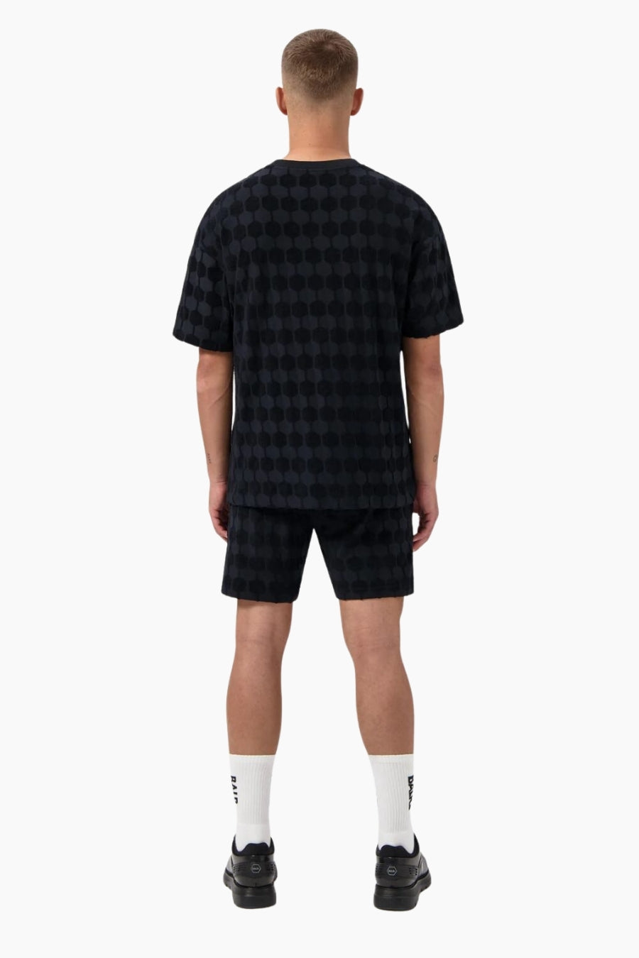 Person wearing a black checkered outfit