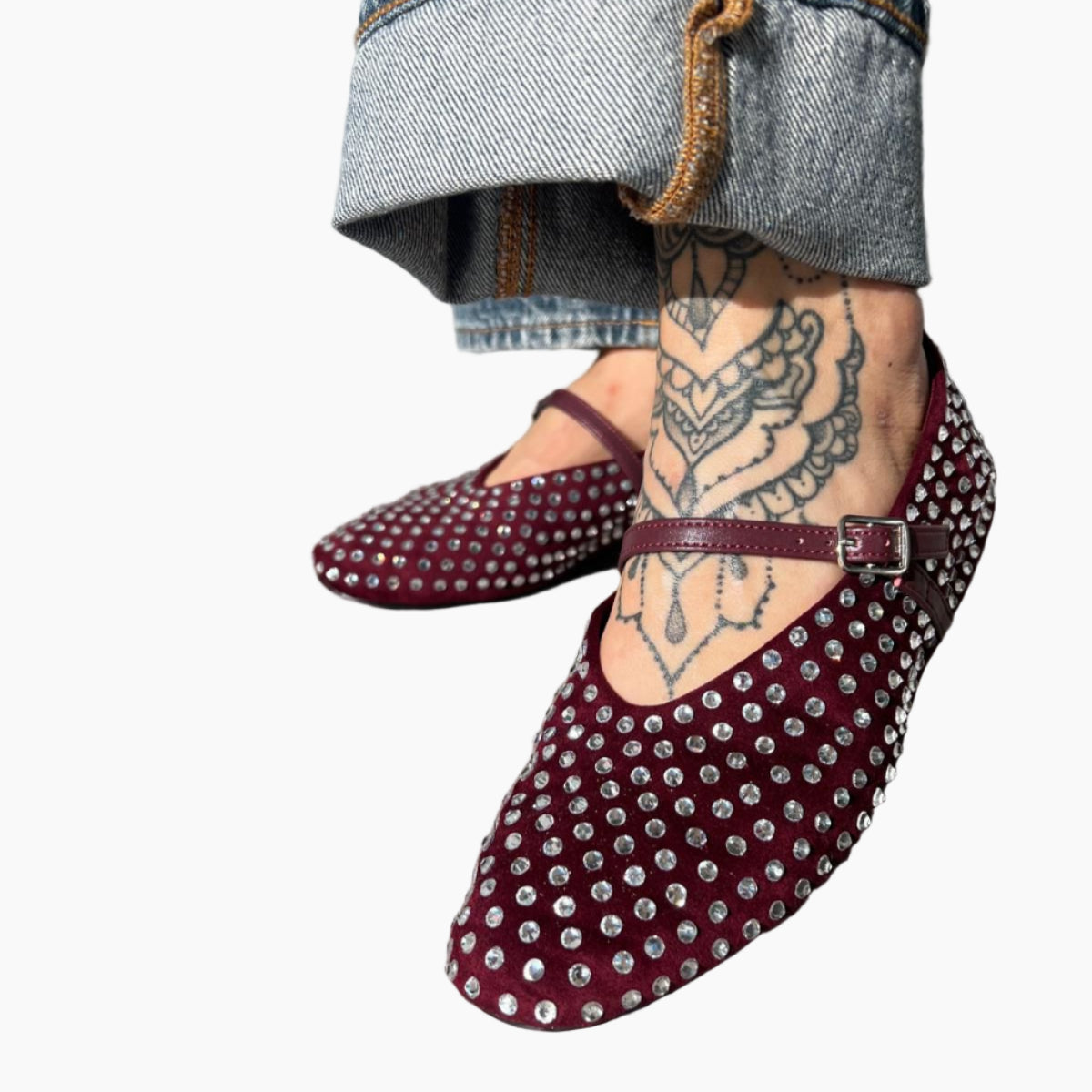 Maroon studded shoes worn with denim jeans