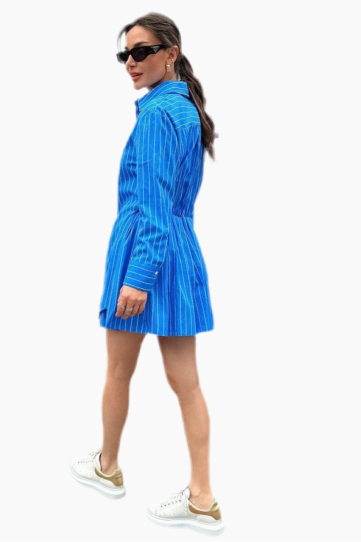 Woman wearing a blue striped dress on a white background