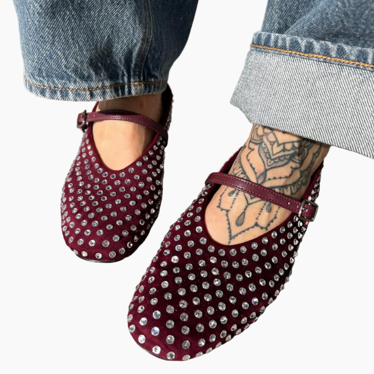 Maroon studded flats worn with blue jeans