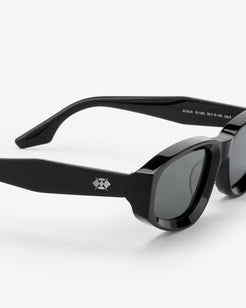Black sunglasses with a brand logo on a white background
